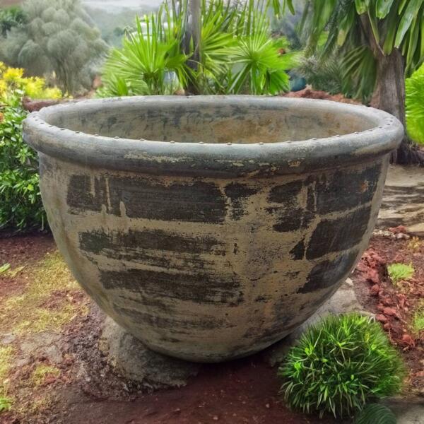 Crafted by hand from premium Thai limestone, this rustic pot features a textured, sandstone finish in a natural yellow-green hue—perfect for creating a lush, tropical feel in any space. Its raw, chiseled rim gives it a bold, sculptural look, making it ideal for both residential gardens and commercial landscaping projects.