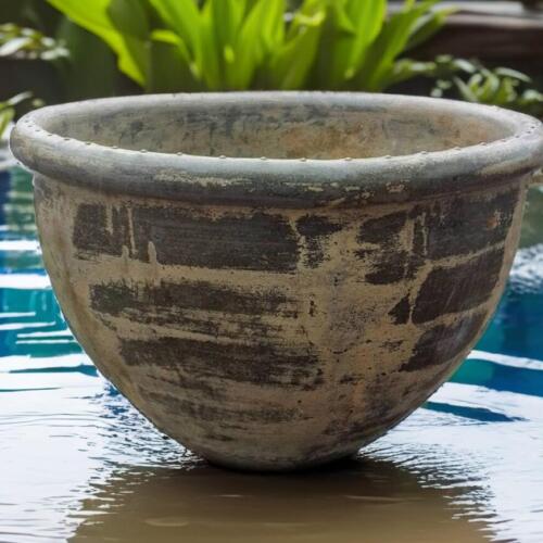 Crafted by hand from premium Thai limestone, this rustic pot features a textured, sandstone finish in a natural yellow-green hue—perfect for creating a lush, tropical feel in any space. Its raw, chiseled rim gives it a bold, sculptural look, making it ideal for both residential gardens and commercial landscaping projects.